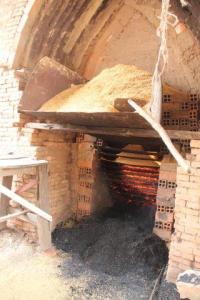 Rice husks sit above the kiln ready to fuel the intense fire